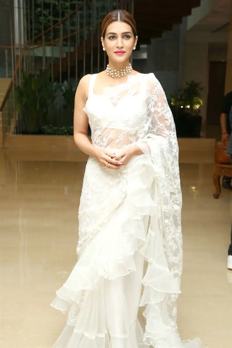 Kriti Sanon Charming Stills In White Saree Sleeveless Blouse